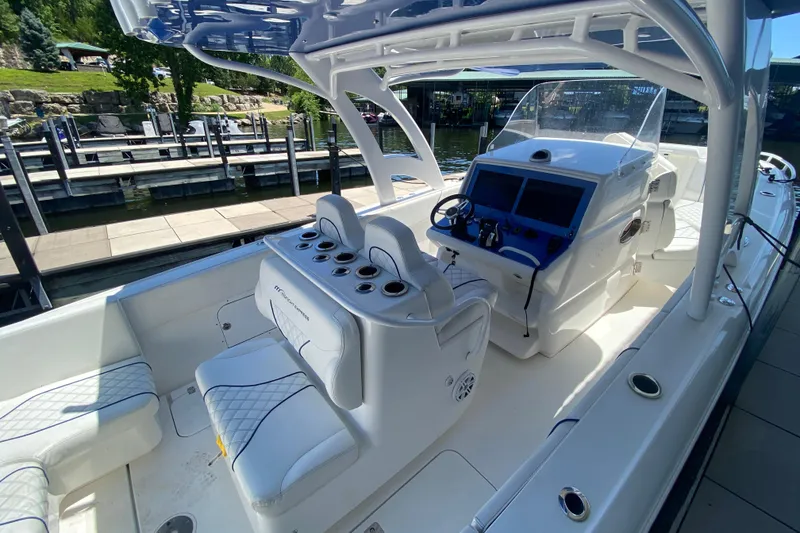 Slide: The Image of 2017 Midnight Express 39S Cuddy boat interior with helm, seating, and dockside view. - 30