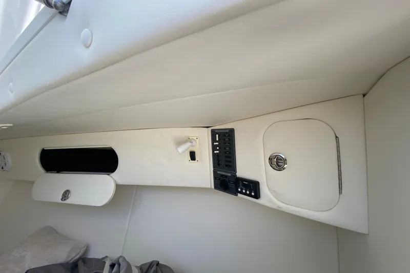 Slide: The Image of Interior of 2017 Midnight Express 39S Cuddy boat, featuring control panel and storage compartments. - 36
