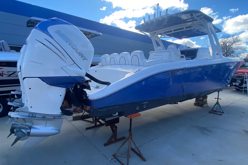 Slide: The Image of 2017 Midnight Express 39S Cuddy boat with Mercury Verado engine, displayed outdoors. - 4