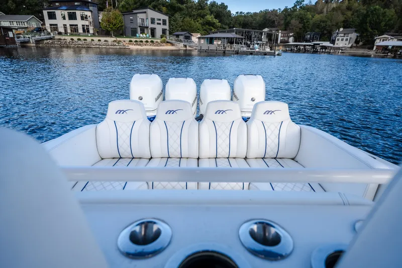 Slide: The Image of 2017 Midnight Express 39S Cuddy boat with luxurious seating and powerful engines on a serene lake. - 33