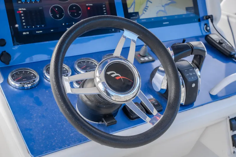 Slide: The Image of Steering wheel and controls of a 2017 Midnight Express 39S Cuddy boat. - 27