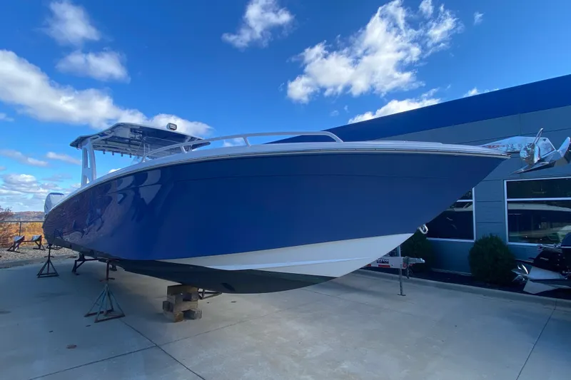 Slide: The Image of 2017 Midnight Express 39S Cuddy boat displayed outdoors under a blue sky. - 5