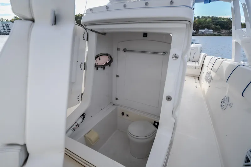 Slide: The Image of 2017 Midnight Express 39S Cuddy boat interior with compact bathroom and seating area. - 47