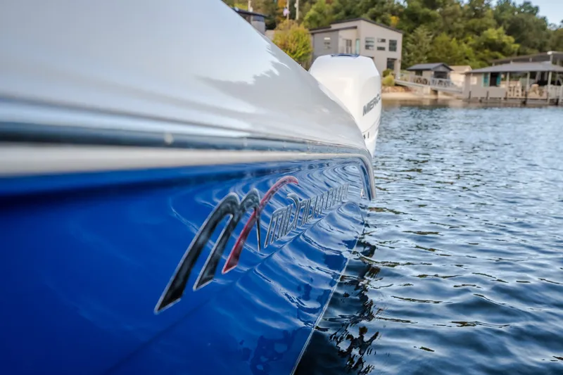 Slide: The Image of 2017 Midnight Express 39S Cuddy boat on water, showcasing sleek blue hull design. - 20