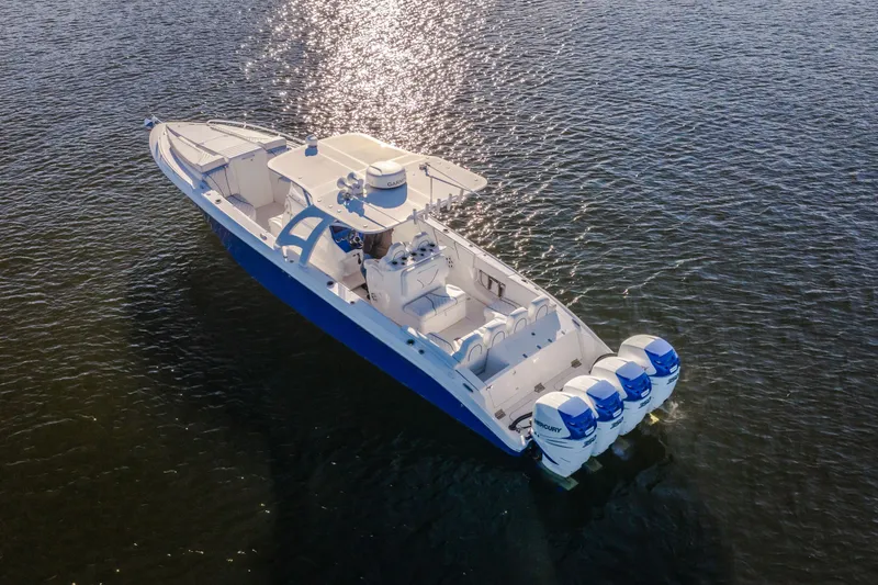 Slide: The Image of 2017 Midnight Express 39S Cuddy boat on water, featuring four powerful engines. - 11