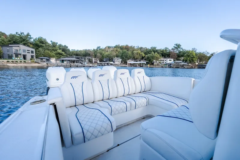 Slide: The Image of Luxurious 2017 Midnight Express 39S Cuddy boat with plush seating on a serene lake. - 19