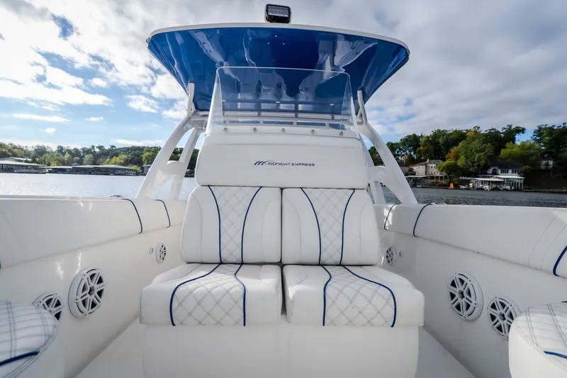 Slide: The Image of 2017 Midnight Express 39S Cuddy boat interior with white seating and blue accents. - 46