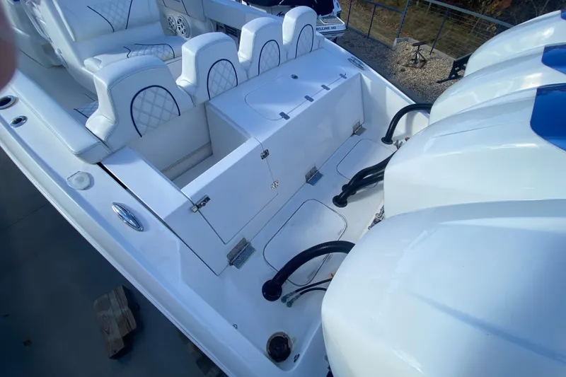 Slide: The Image of 2017 Midnight Express 39S Cuddy boat interior with seating and engine view. - 8