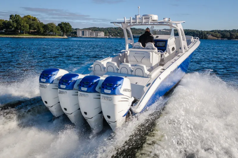 Slide: The Image of 2017 Midnight Express 39S Cuddy boat cruising with four powerful engines on a scenic lake. - 34