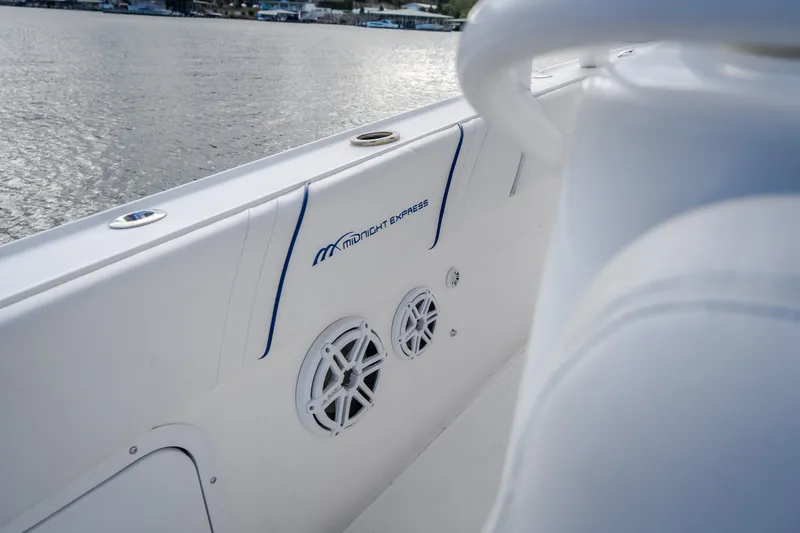 Slide: The Image of 2017 Midnight Express 39S Cuddy boat interior with speakers, on calm water. - 52