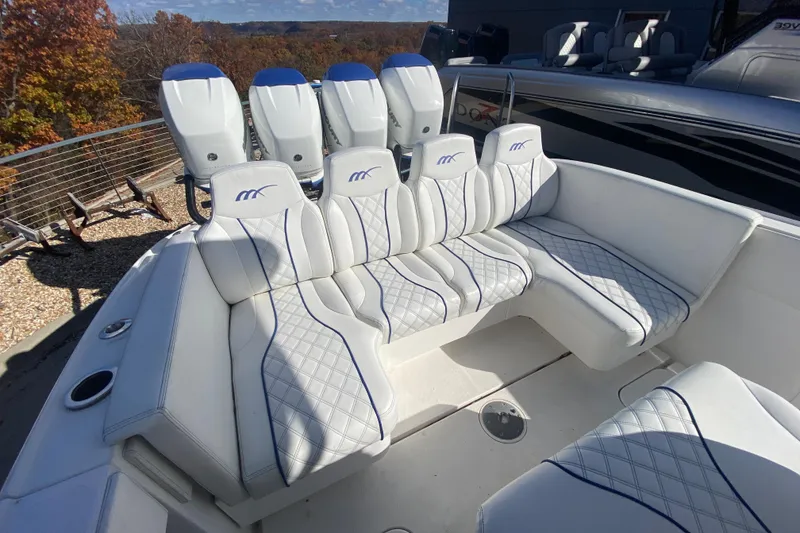 Slide: The Image of 2017 Midnight Express 39S Cuddy boat with luxurious white seating and multiple engines. - 9