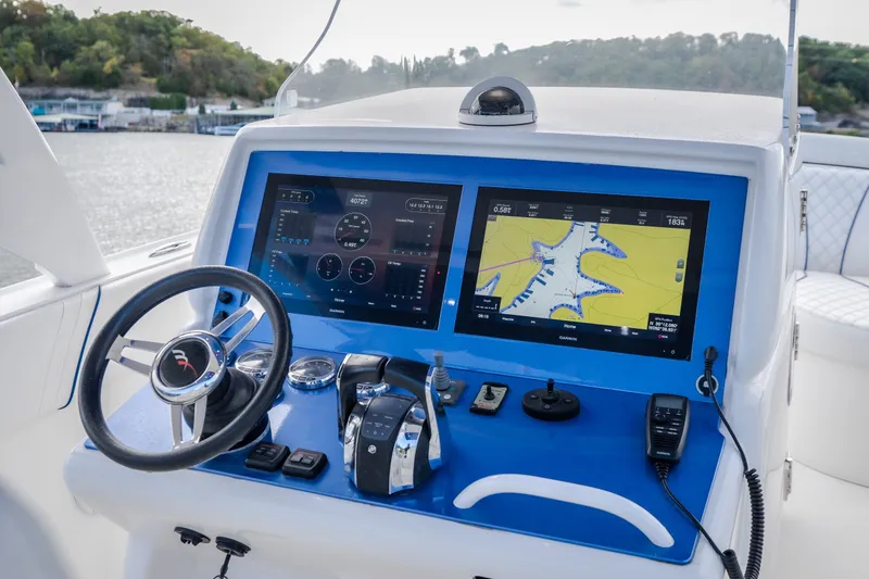 Slide: The Image of Helm of 2017 Midnight Express 39S Cuddy with dual navigation screens and steering wheel. - 25
