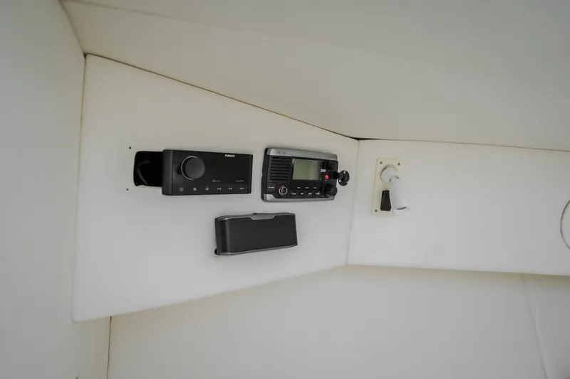 Slide: The Image of Control panel of a 2017 Midnight Express 39S Cuddy boat, featuring radio and controls. - 43