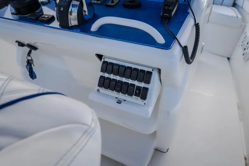Slide: The Image of Control panel of a 2017 Midnight Express 39S Cuddy boat with switches and radio. - 31