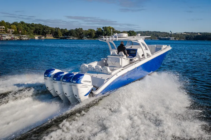 Slide: The Image of 2017 Midnight Express 39S Cuddy boat cruising on a lake with four engines. - 12