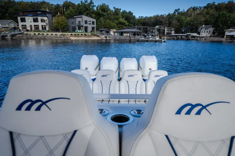 Slide: The Image of 2017 Midnight Express 39S Cuddy boat with multiple engines on a serene lake. - 32