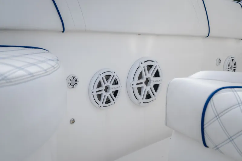 Slide: The Image of 2017 Midnight Express 39S Cuddy boat interior with JL Audio speakers and cushioned seating. - 49