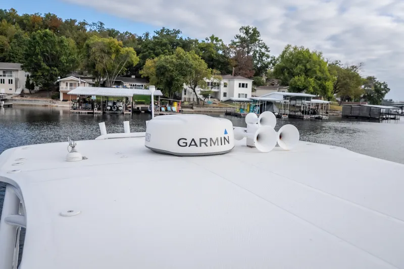 Slide: The Image of 2017 Midnight Express 39S Cuddy boat with Garmin radar, docked near waterfront homes. - 55