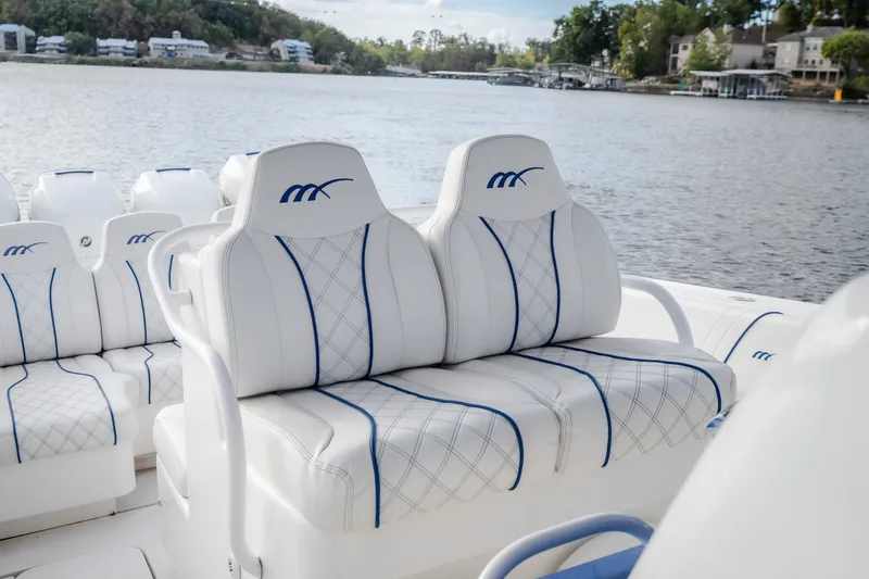 Slide: The Image of 2017 Midnight Express 39S Cuddy boat with luxurious white seating on a serene lake. - 36