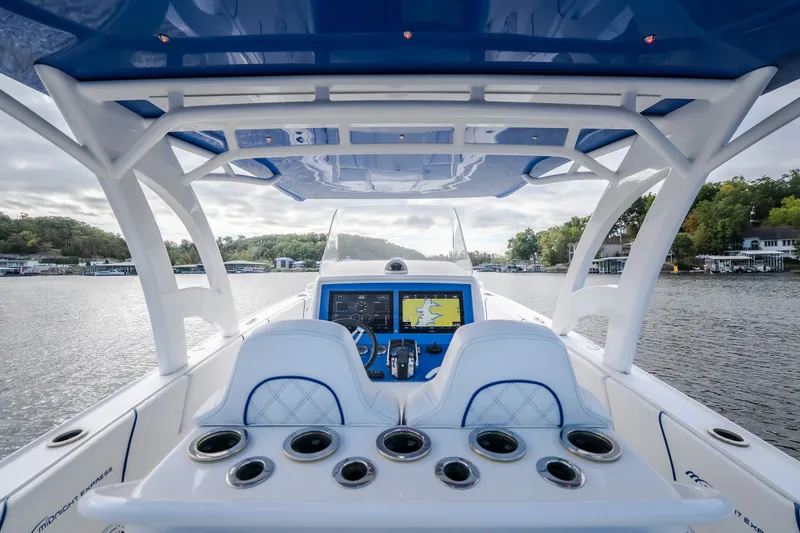Slide: The Image of Cockpit view of 2017 Midnight Express 39S Cuddy boat on a scenic lake. - 23