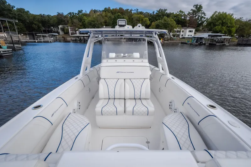 Slide: The Image of 2017 Midnight Express 39S Cuddy boat with luxurious seating on a serene lake. - 45