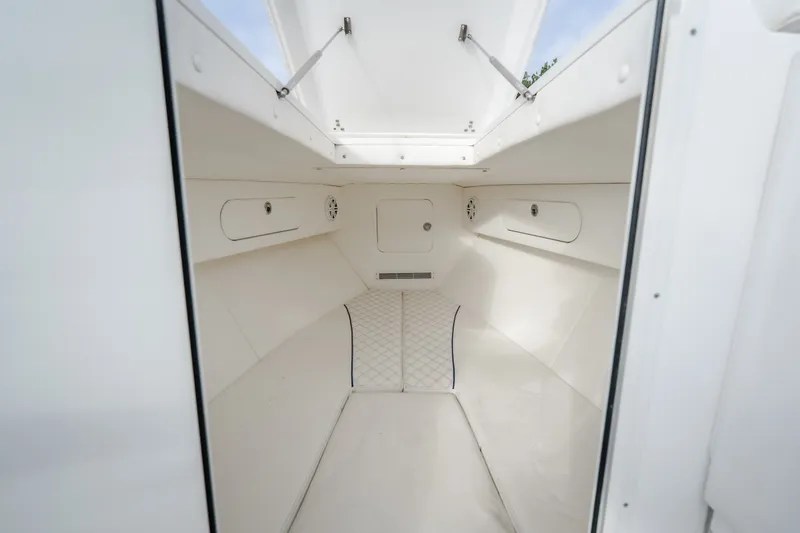 Slide: The Image of Interior cabin of 2017 Midnight Express 39S Cuddy boat, featuring white upholstery and storage compartments. - 41