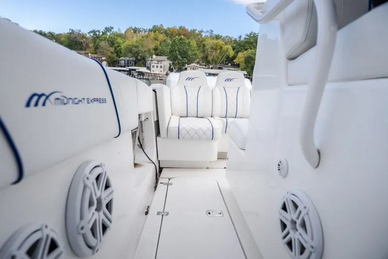 Slide: The Image of Interior view of 2017 Midnight Express 39S Cuddy boat with white seating and speakers. - 21