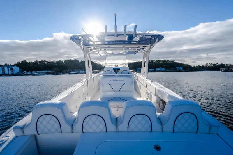 Slide: The Image of 2017 Midnight Express 39S Cuddy boat on calm water, featuring luxurious seating and sleek design. - 54