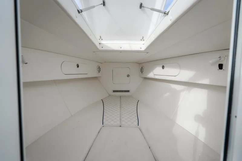 Slide: The Image of Interior cabin of 2017 Midnight Express 39S Cuddy boat, featuring sleek white design. - 42
