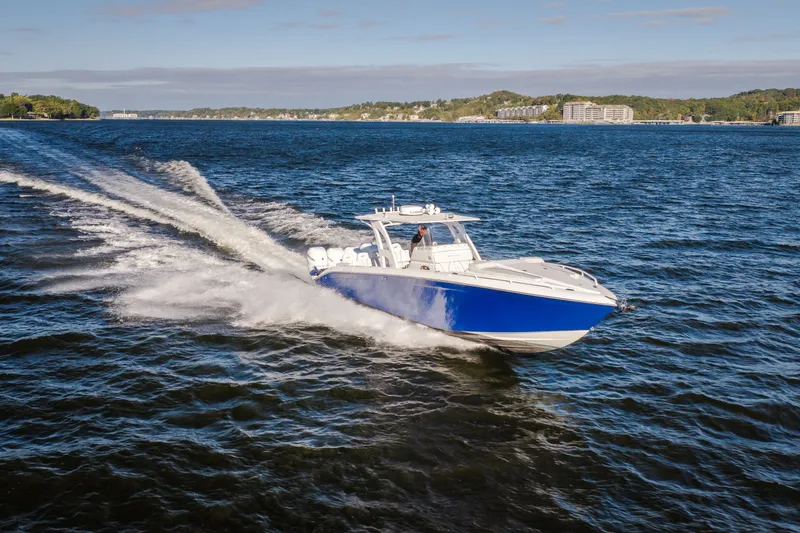 Slide: The Image of 2017 Midnight Express 39S Cuddy cruising on a scenic lake under clear skies. - 6