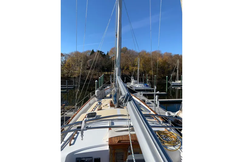 Slide: The Image of 1981 Hardin 45 sailboat docked, surrounded by autumn trees and clear blue sky. - 11