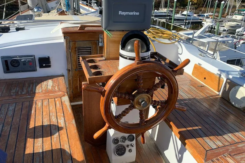 Slide: The Image of Wooden helm of a 1981 Hardin 45 sailboat with Raymarine equipment. - 12