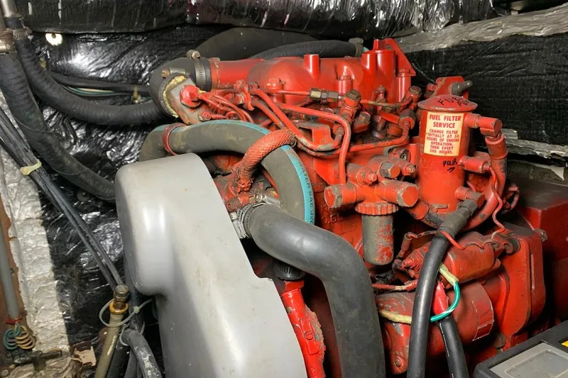 Slide: The Image of Red engine in a 1981 Hardin 45 boat, featuring fuel filter service instructions. - 17