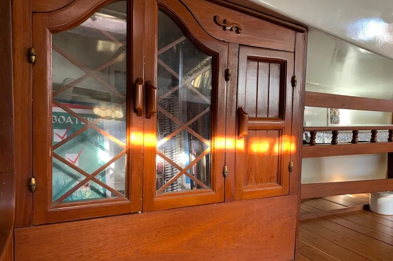 Slide: The Image of Wooden interior of a 1981 Hardin 45 boat with sunlight on cabinets. - 24