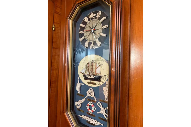 Slide: The Image of Nautical-themed clock with ship and rope designs, set in a wooden frame. Hardin 45, 1981. - 25