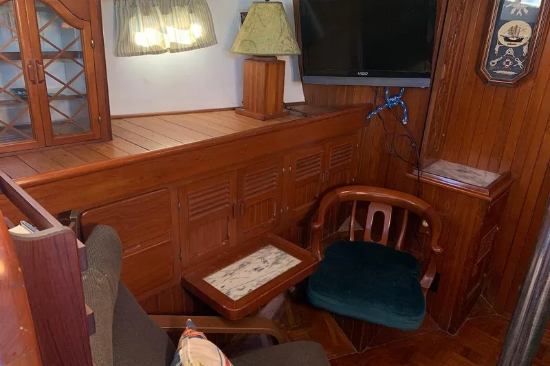 Slide: The Image of Interior of a 1981 Hardin 45 yacht with wooden furnishings and a mounted TV. - 28