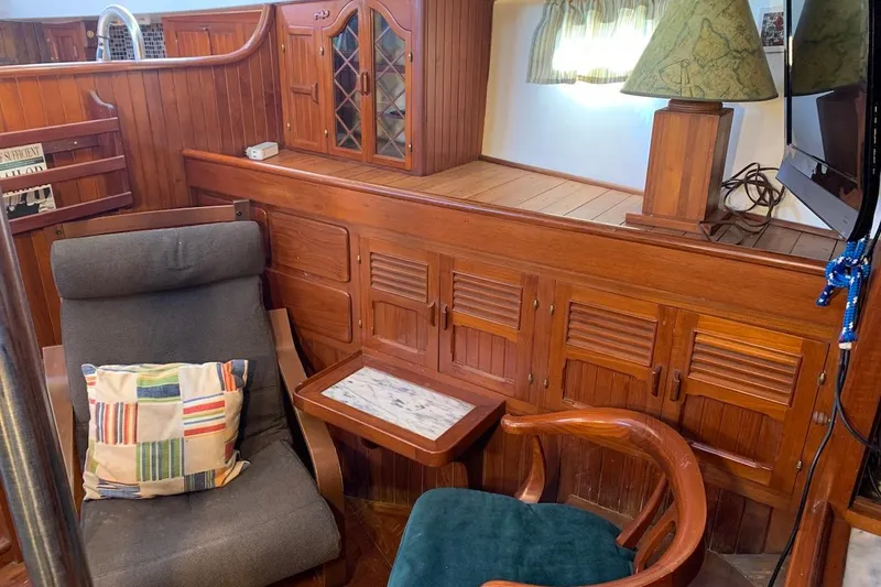Slide: The Image of Interior of a 1981 Hardin 45 yacht with wooden cabinetry and cozy seating. - 29