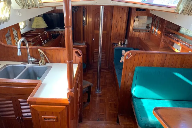 Slide: The Image of Interior of 1981 Hardin 45 sailboat with wood finish and teal seating. - 3