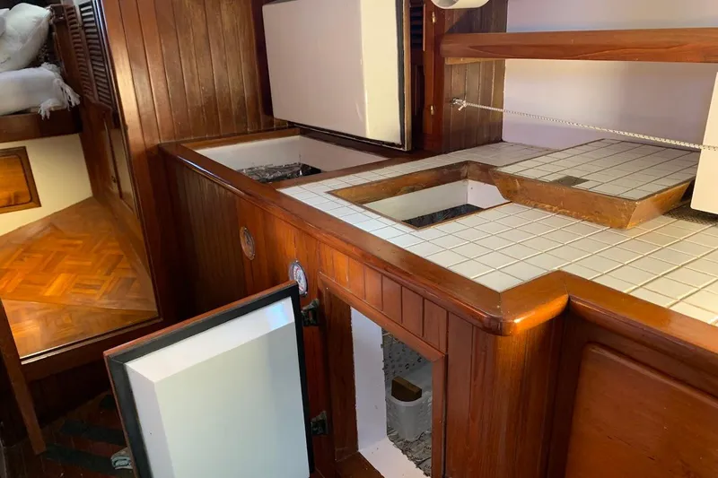 Slide: The Image of Interior of 1981 Hardin 45 yacht with wooden cabinetry and tiled countertops. - 31