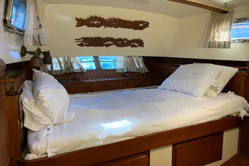 Slide: The Image of Cozy cabin interior of 1981 Hardin 45 sailboat with wooden accents and comfortable bedding. - 34