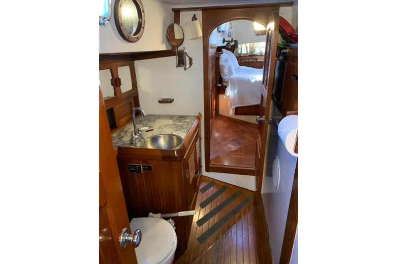 Slide: The Image of Interior of 1981 Hardin 45 yacht featuring a compact bathroom with wooden accents. - 36