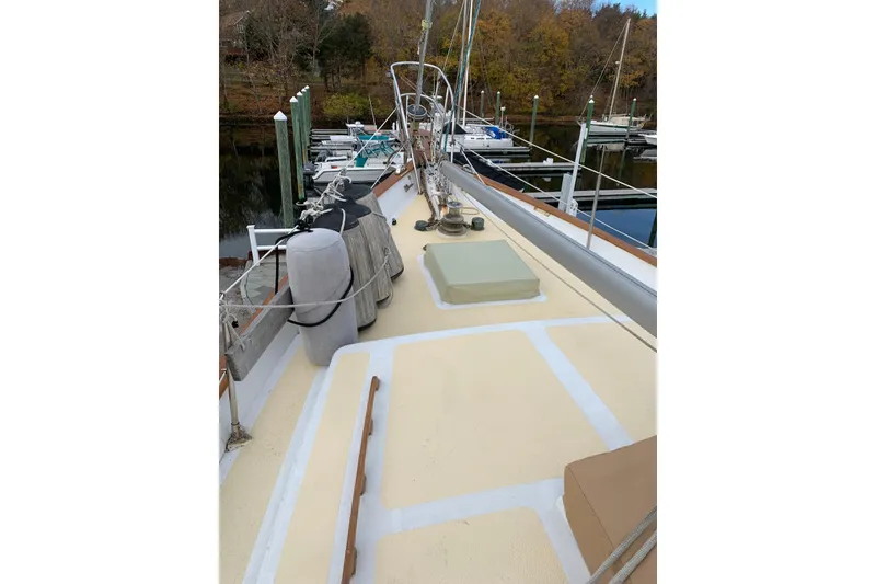 Slide: The Image of 1981 Hardin 45 sailboat deck with marina view, featuring clean lines and mooring equipment. - 4