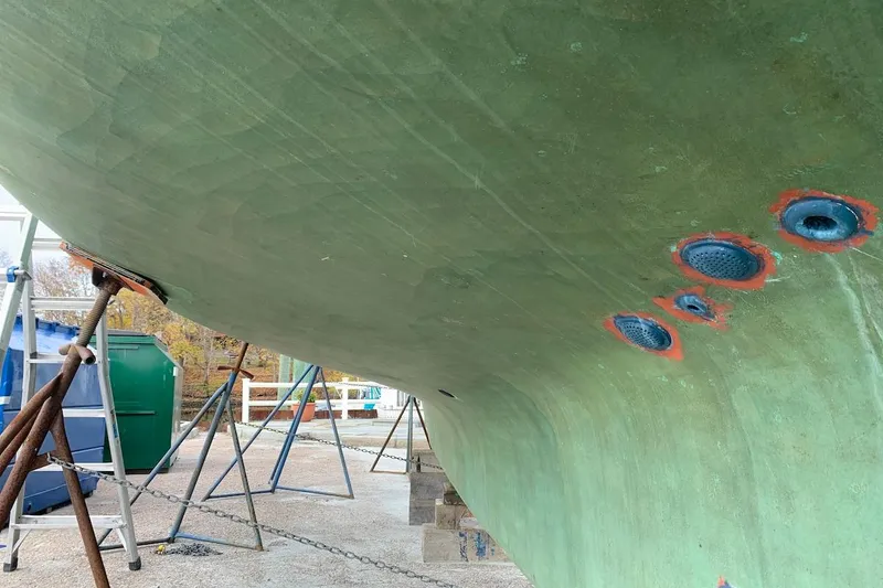 Slide: The Image of Bottom view of a 1981 Hardin 45 sailboat hull on stands, showing through-hull fittings. - 46