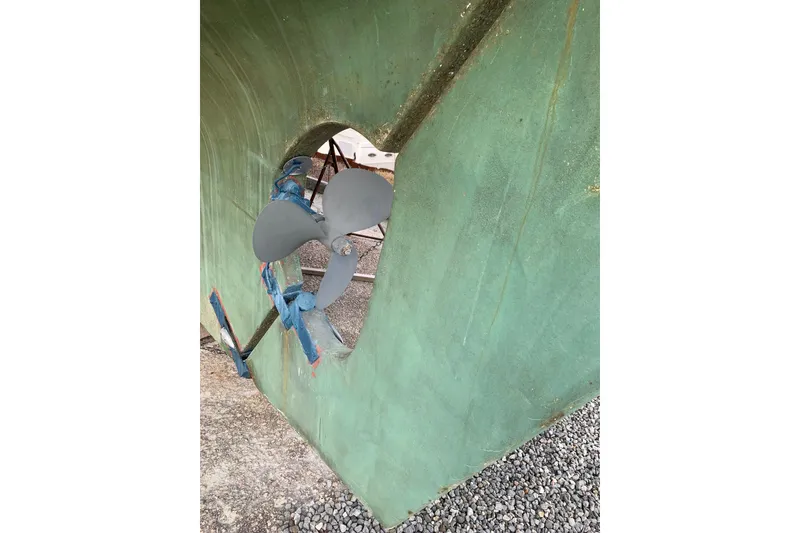 Slide: The Image of Propeller of 1981 Hardin 45 sailboat on dry dock, green hull visible. - 50