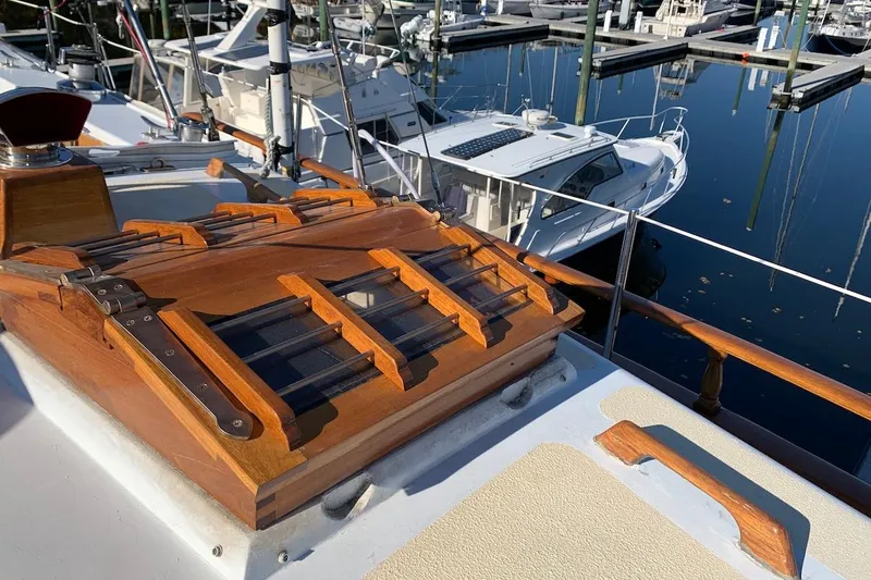 Slide: The Image of Wooden hatch on 1981 Hardin 45 sailboat, docked in marina with other boats. - 8