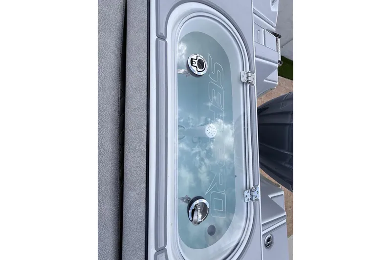 Slide: The Image of 2024 Sea Pro 222 Center Console livewell with clear lid and secure latches. - 11