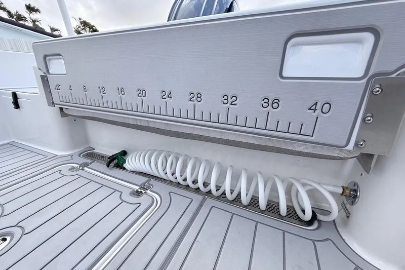Slide: The Image of 2024 Sea Pro 222 Center Console boat deck with measuring ruler and coiled hose. - 13