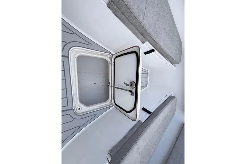 Slide: The Image of 2024 Sea Pro 222 Center Console boat storage compartment with open hatch and seating. - 19