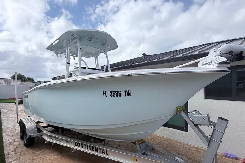 Slide: The Image of 2024 Sea Pro 222 Center Console boat on trailer, parked outdoors. - 27