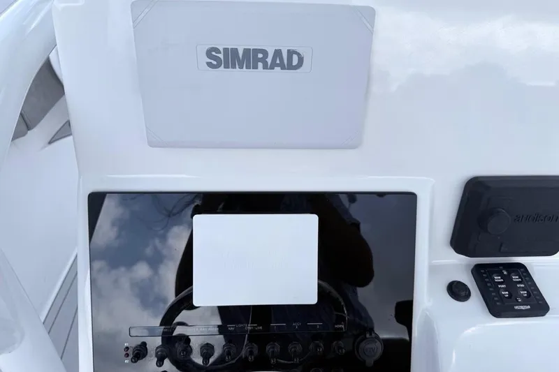 Slide: The Image of 2024 Sea Pro 222 Center Console dashboard with Simrad electronics and control panel. - 5
